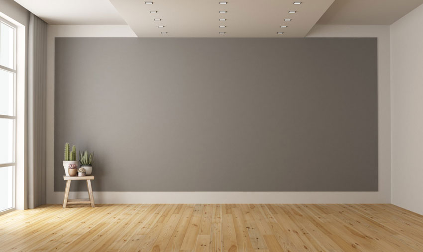 Parete grigia in una stanza con parquet.